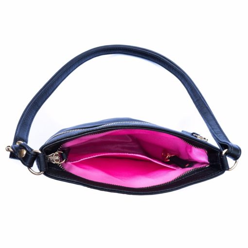 A black purse with pink lining and a strap.