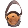 A brown leather bag with an open pocket.