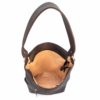 A brown leather bag with a handle and a black strap.