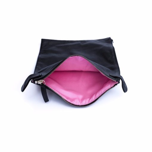 A black purse with pink lining and zipper.