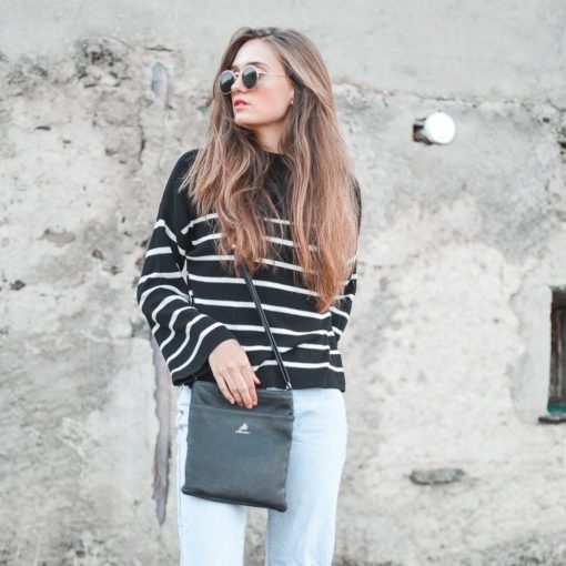 A woman in sunglasses and a striped sweater.