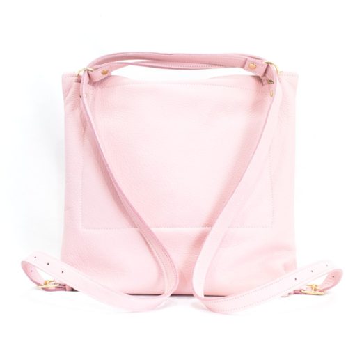A pink backpack with a strap on the back.