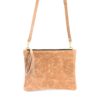 A tan purse with a tassel hanging from the front.