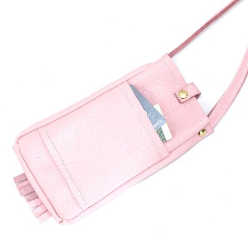 A pink purse with a cell phone and pen in it.