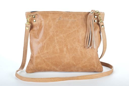 A tan leather purse with a long strap.