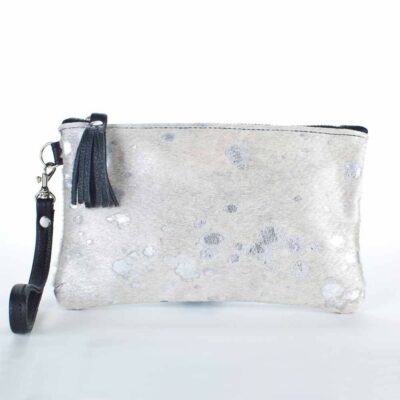 A silver purse with black strap and white spots