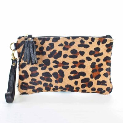 A leopard print purse with black strap and tassel.