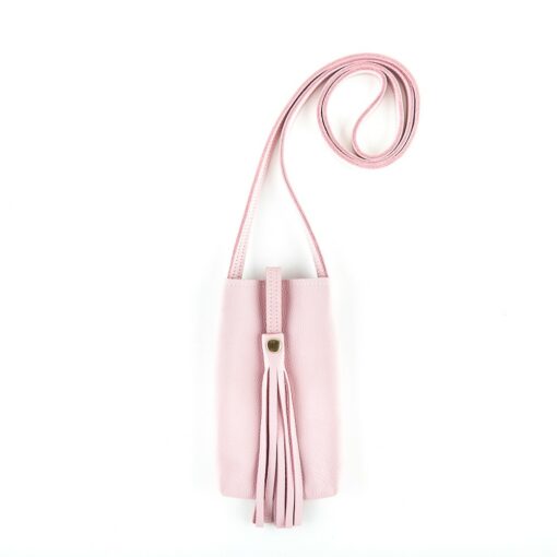 A pink purse with a long strap hanging from the side.