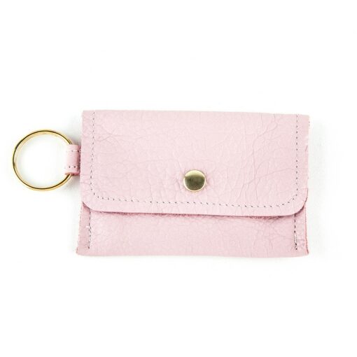 A pink wallet with a key chain attached.