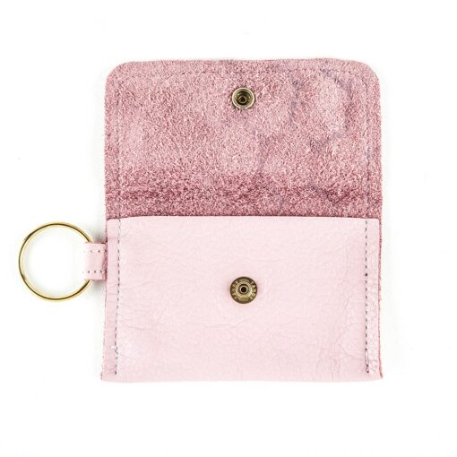 A pink wallet with a key chain attached to it.