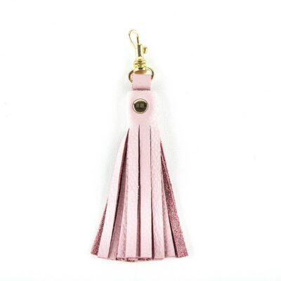 A pink leather tassel keychain with gold accents.