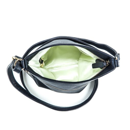 A black purse with a green lining inside of it.