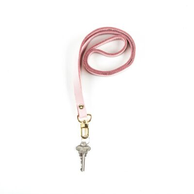 A pink lanyard with a key on it.