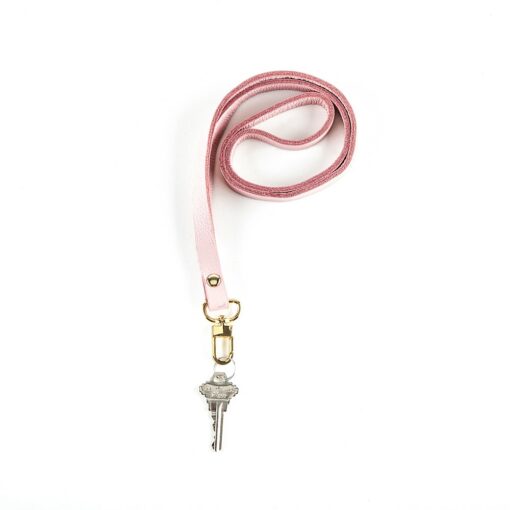 A pink lanyard with a key on it.